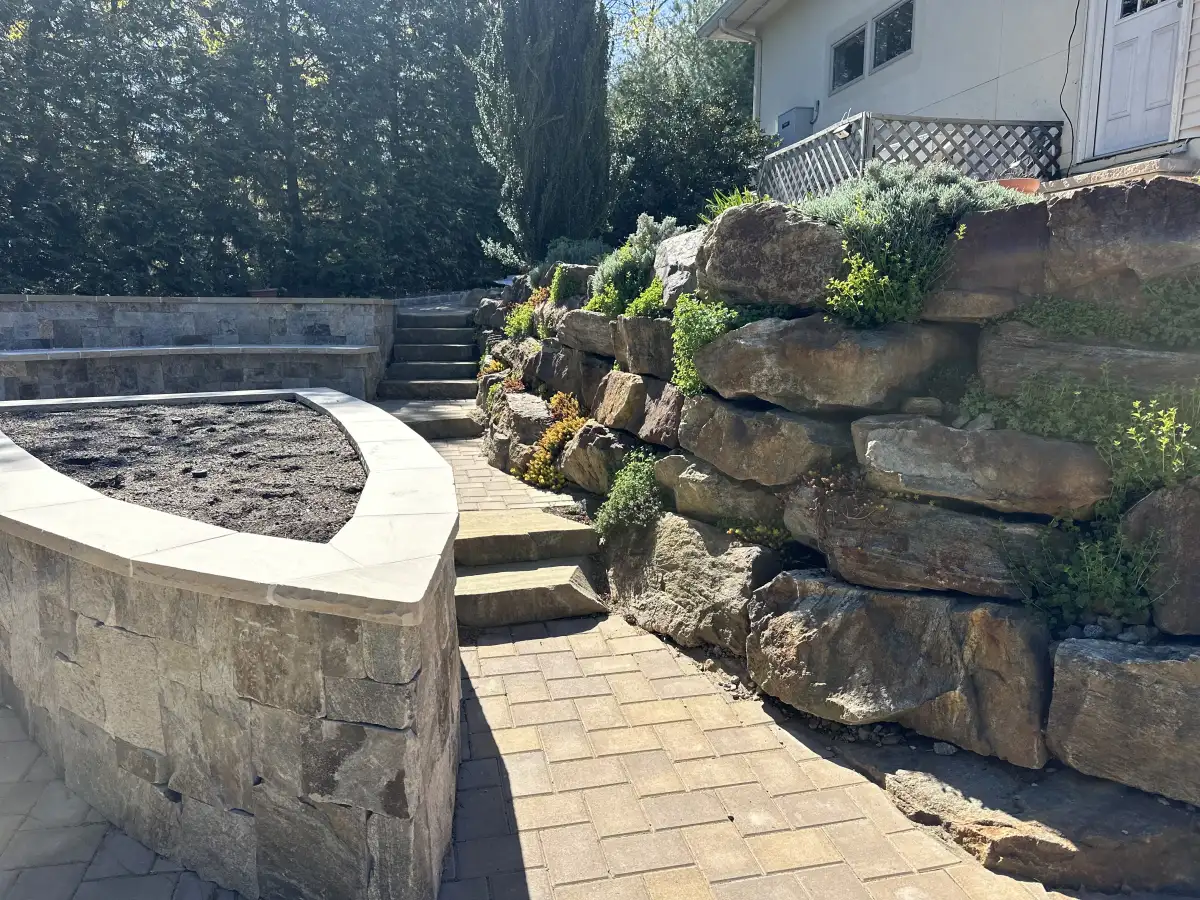 Stone walkway and retaining features from a Bernicker and Son hardscaping project
