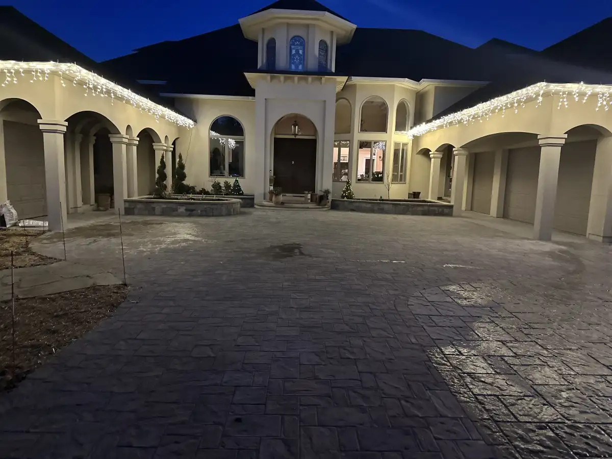 Finished hardscape courtyard with patterned paving and stone-edged planting beds
